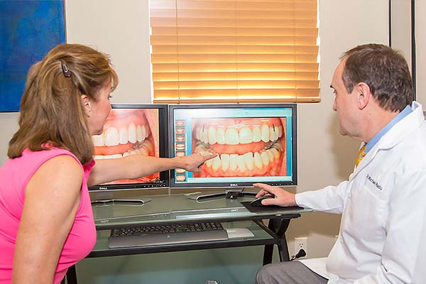 Patient being shown the results of cosmetic dentistry